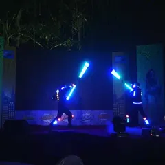 For an SBI event with a superhero theme, I had my performers use glowing blue light staffs to create a futuristic sword-fighting sequence. This shows how I can adapt my LED shows to fit any creative concept, making the entertainment a core part of the event narrative.