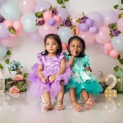 Double the trouble, double the fun. These adorable twin sisters are celebrating their second birthday in our studio with a pastel fairy-themed setup.