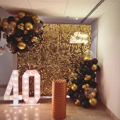 We believe your 40th should be nothing short of spectacular. For this celebration, we created a glamorous black and gold theme with a shimmering sequin wall, marquee numbers, and sophisticated balloon clusters to set a truly celebratory mood.
