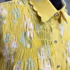 A close-up shot of the Chanderi floral embroidered shirt. This view highlights the detailed smocking and the texture of the floral threadwork, showcasing the quality of the craftsmanship.