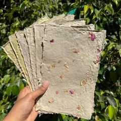 A stack of my latest batch of handmade paper, created from recycled newspaper and infused with dried rose petals. It's not perfect, but each sheet tells a story of transformation and learning.