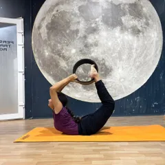 Using the yoga wheel to move into a full Dhanurasana (Bow Pose), this student shows how props can help achieve advanced postures.
