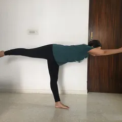 A student practicing Virabhadrasana III (Warrior III) at home. This balancing pose strengthens the legs and core while improving focus, all achievable through my online guidance.
