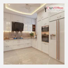 A look at a timeless all-white U-shaped kitchen. This design maximizes space with floor-to-ceiling cabinetry, integrated double ovens, and a dedicated space for a side-by-side refrigerator, creating a bright and highly functional cooking environment.