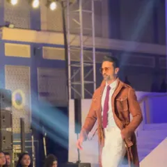 On the runway, our brown belted long coat makes a statement. This is a versatile piece of outerwear, perfect for the fashion-conscious gentleman.