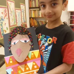 As part of our "Project Africa," students create mixed-media portraits inspired by tribal art. This piece uses paper collage and beads to create a wonderfully textured and colorful result.