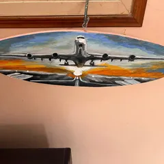 Fly high! I loved painting on this unique oval wooden canvas. This piece captures an airplane during takeoff, with the warm colors of the sunset reflecting on the runway. It’s a dynamic piece that evokes the excitement of travel and new beginnings.