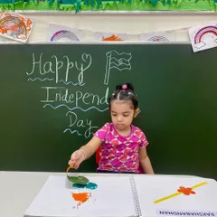 Carefully dabbing paint with a leaf, this student creates her own tricolor artwork. This activity not only teaches about national symbols but also enhances fine motor control and creativity.