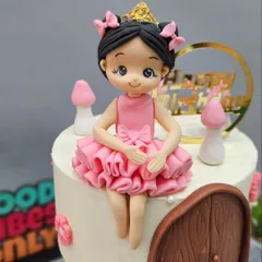 The delicate ballerina figurine sitting atop the floating cake tier. Every element, from the ruffled dress to the tiny crown, is crafted by hand to complete the story.