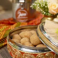 Our Atta Laddoos, packed in a traditional container. These are not just sweets, they are a warm hug on a cold day.