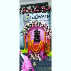 We created this beautiful mandap for the Ganpati festival inside the Radware office. The setup includes a floral arch over the deity, marigold garlands, and a decorated platform, providing a dedicated space for worship.