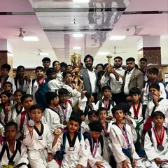 The whole team celebrating our victory at the Warriors Cup. This large group photo captures the collective spirit and success of all my students, from the youngest beginners to the senior belts, each one a champion.