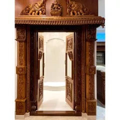 This intricately carved teak wood door was custom-designed for a pooja room. It showcases our expertise in traditional Indian craftsmanship, with detailed carvings of elephants and deities that create a truly divine entrance.