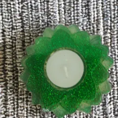 This vibrant green T-light holder is infused with glitter for a sparkling effect. It's a fun and festive option that can add a pop of color to your event decor or serve as a cheerful return gift for your guests.
