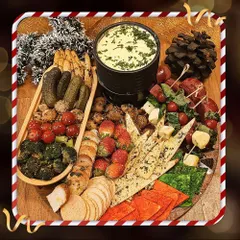 Our Cheese Fondue platter is perfect for cozy holiday gatherings. We serve the warm, creamy cheese fondue with a festive spread of dippables, including bread, crackers, roasted vegetables, and strawberries.
