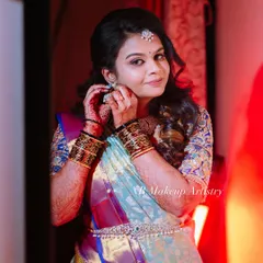 A candid moment of Nithya getting ready for her event. This shot captures the beauty of the final look, with glowing skin and defined eyes that photograph beautifully.