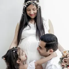The whole family is excited to meet the new arrival. This maternity family portrait captures the love between parents and their older child as they look forward to becoming a bigger family.
