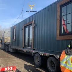 Your custom home, on the move. This unit is securely loaded onto a flatbed truck, showcasing the true portability of our container-based living solutions.