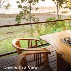Dine with a view. This table for two on a private deck overlooking the water is the perfect spot for a quiet, scenic meal.