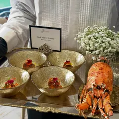 A tray of Black Pepper Lobster, complete with a whole lobster for presentation, showcasing the level of luxury we bring to corporate events.