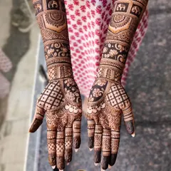 A classic Indian bridal design for Sumana. This intricate work features elephant motifs in the forearm bands, along with detailed checkerboard patterns, florals, and paisleys covering the hands.
