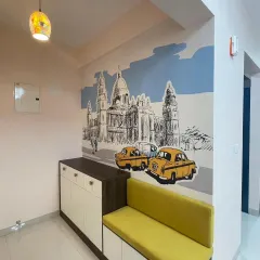 A charming sketch-style mural of a city scene, possibly Bengaluru or Kolkata, with classic cars. This design adds a touch of nostalgia and urban character to this entryway.
