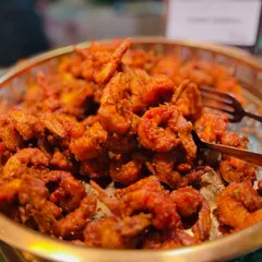 A tempting bowl of crispy Prawns Koliwada, a spicy and flavorful fried prawn dish that is a Mumbai specialty. It's the perfect appetizer to kick off any celebration.