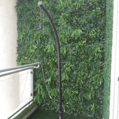 Even a small balcony can become a cozy green corner. Here, I've installed a vertical garden wall and artificial grass flooring to create a private, lush retreat.