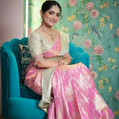 For this muhurtam look, I created a stunning Langa Voni, or half saree, in a vibrant pink brocade. The heavily embroidered cream blouse adds a touch of regal elegance, perfect for a bride's special day.