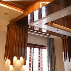 This image showcases custom wooden rafters with integrated spotlights, creating a warm and dramatic lighting effect. The automated blinds on the window allow for easy adjustment of natural light to complement the interior lighting.