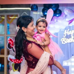 A mother's joy is so pure, especially on her baby's first birthday. This candid moment, with the little one dressed as a fairy, is exactly the kind of precious memory I aim to freeze in time during birthday celebrations.