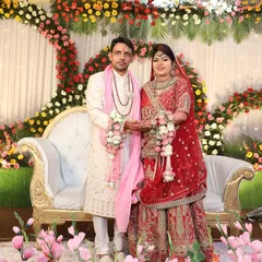Richa and Puneet stand amidst a beautiful floral arrangement during their wedding reception. Their story, stretching from Himachal to Delhi, is a testament to how light-hearted conversations can blossom into a life of togetherness.