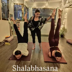 Shalabhasana (Locust Pose) requires significant back and core strength. Here, my students are holding the pose, lifting their legs and chest off the floor.