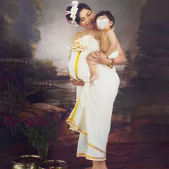 A beautiful moment between a mother and her first child as they await the new baby. Dressed in a traditional Kasavu saree, she holds her son close, creating a portrait full of love and heritage.