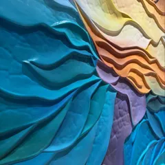 Another detailed shot of the wave sculpture, focusing on the crisp edges and the way the different colored sections interlock to create a sense of movement.
