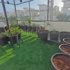 Here you can see a terrace garden in progress, with the artificial turf laid and pots ready for planting. This setup allows for a clean, soil-free environment that is easy to manage.