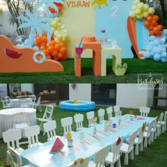 A fun and sunny summer pool party theme for Vihaan's 2nd birthday. The outdoor setup included a kids' dining table, a small pool, and bright, beach-themed props like surfboards and palm trees.