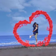 A creative beach shot where we use red smoke to form a heart shape around the couple, making for a unique and memorable pre-wedding photo.