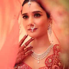A classic red bridal look will always be iconic. Peeking through the veil, this shot captures the soft yet regal glam I created for her, focusing on elegant eyes and a finish that feels both traditional and modern.