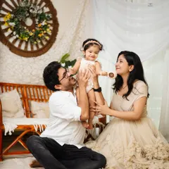 A playful moment with dad lifting his daughter high in the air. This photo is full of laughter and movement, capturing the fun side of family life.