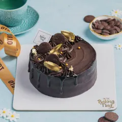 This is the most loved cake on my menu, the OTB Celebration Cake. It's a moist chocolate sponge with smooth ganache, topped with swirls and a mini mandola cookie.
