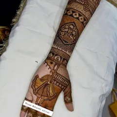 A single-hand view showing the rich, brown-red stain of the intricate arm patterns.