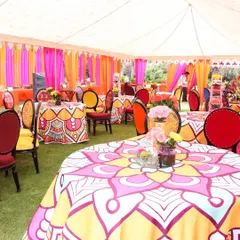 The decor is in the details. We used custom-printed tablecloths with vibrant patterns and multi-colored chairs to bring the "Rangeela Rajasthan" theme to life in the guest dining area.