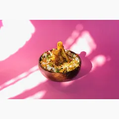 The same mutton biryani, captured with creative shadow play to add depth and an artistic touch. This variation can be used for social media posts or promotional banners.