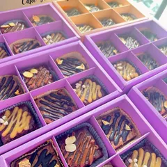 Boxes of my assorted fudgy brownies, ready to be packed as return favors. Each brownie is drizzled with chocolate and topped with nuts for extra flavor and crunch.