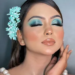 Another angle of the dramatic blue smokey eye, showing how the glitter catches the light. This is a fantastic option for an evening event where you want your makeup to stand out.