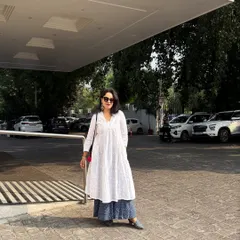 A full-length view of the white kurta ensemble, showcasing its flow and elegance in an outdoor setting. Your style should empower you, whether you are indoors or on the move.