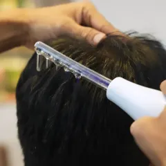 For a truly healthy scalp, I use advanced treatments like this high-frequency comb. It's an effective, non-invasive way to address concerns like dandruff and hair fall by stimulating circulation and promoting a clean, healthy foundation for your hair.