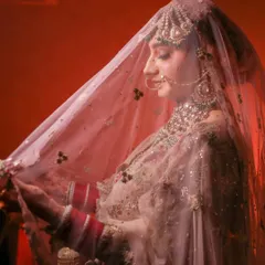 A beautiful shot of the bride under her veil, creating a soft, romantic, and traditional bridal portrait.