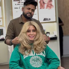 A trendy soft wolf medium-length layered haircut with curtain bangs. This is a very modern and popular style that adds a lot of texture.